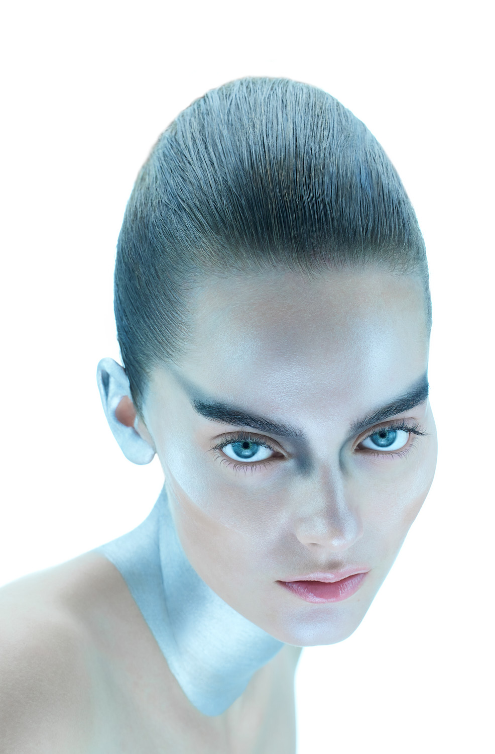 Close-up portrait with shimmering silver face paint, shot by Vikram Pathak, beauty photographer in New York