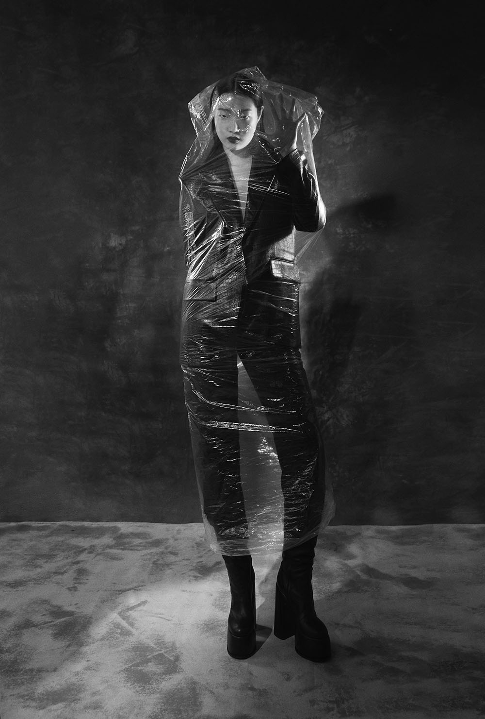 NY Fashion and Beauty Photography - Model in black suit wrapped in transparent plastic for avant-garde editorial fashion portrait by Vikram Pathak 