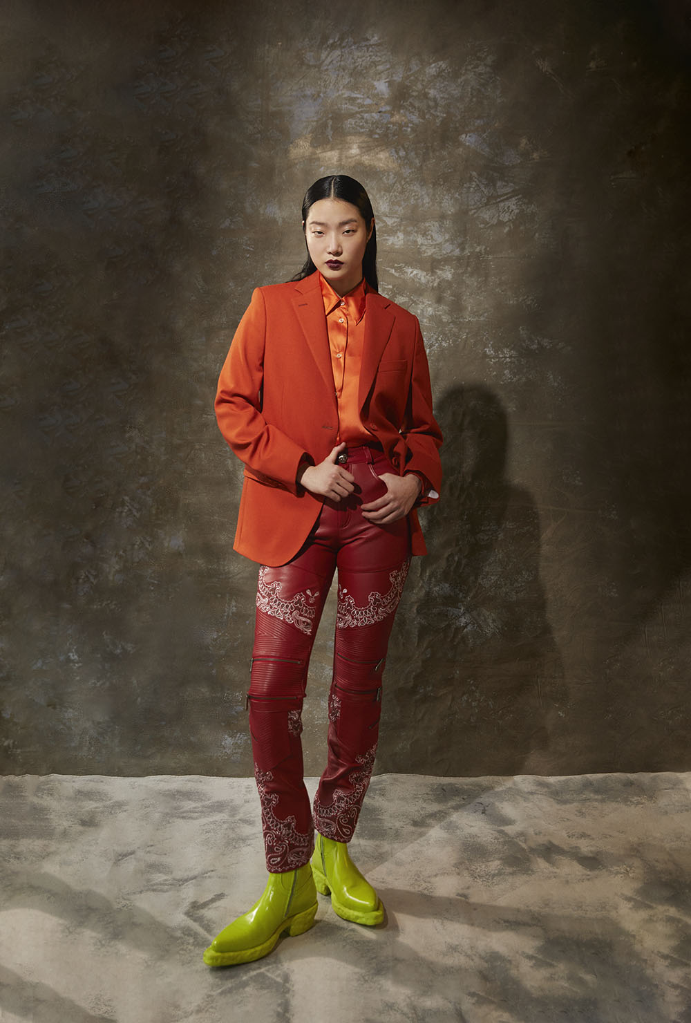 Best Fashion Photographer in New York - Model wearing orange blazer, satin shirt, red patterned pants and neon green boots in fashion editorial By Vikram Pathak 