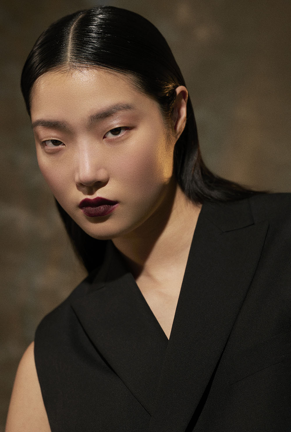 Fashion and Beauty Photographer in NYC - Close-up fashion portrait of model in sleeveless black suit with bold lipstick in studio editorial by Vikram Pathak