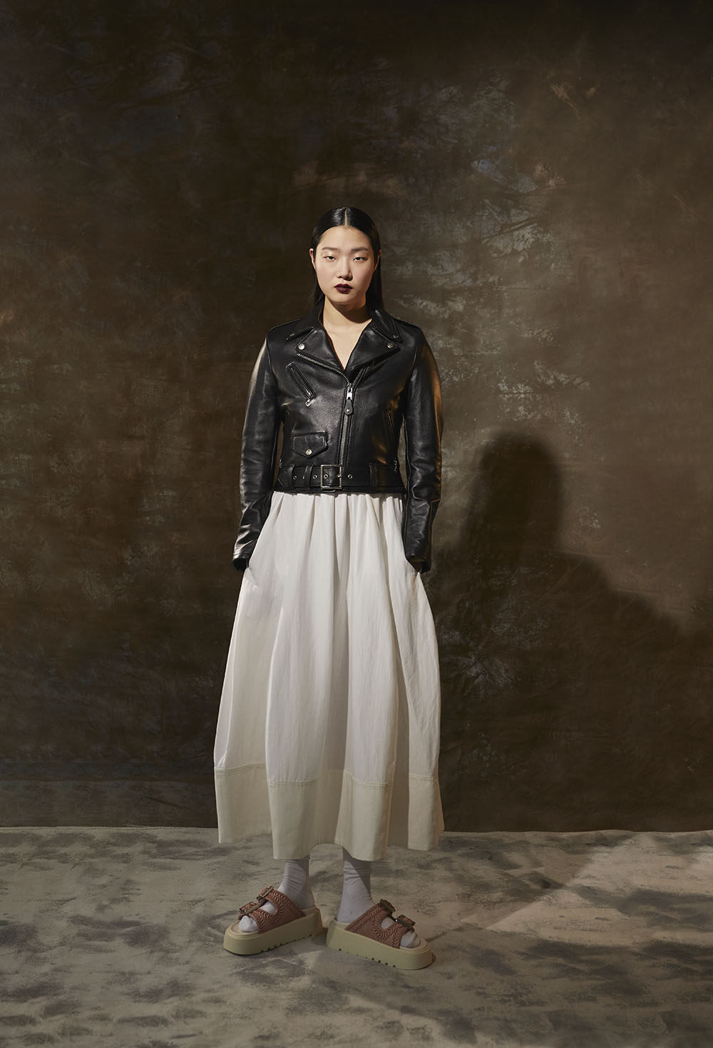 Ny Fashion Photographer-Model in cropped black leather jacket over flowing white dress with platform sandals in studio editorial by Vikram Pathak