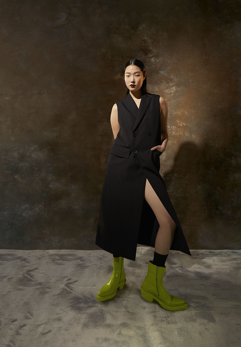 Fashion Photographer NY-Model in sleeveless black dress with thigh-high slit and neon boots in editorial studio shot by Vikram Pathak 