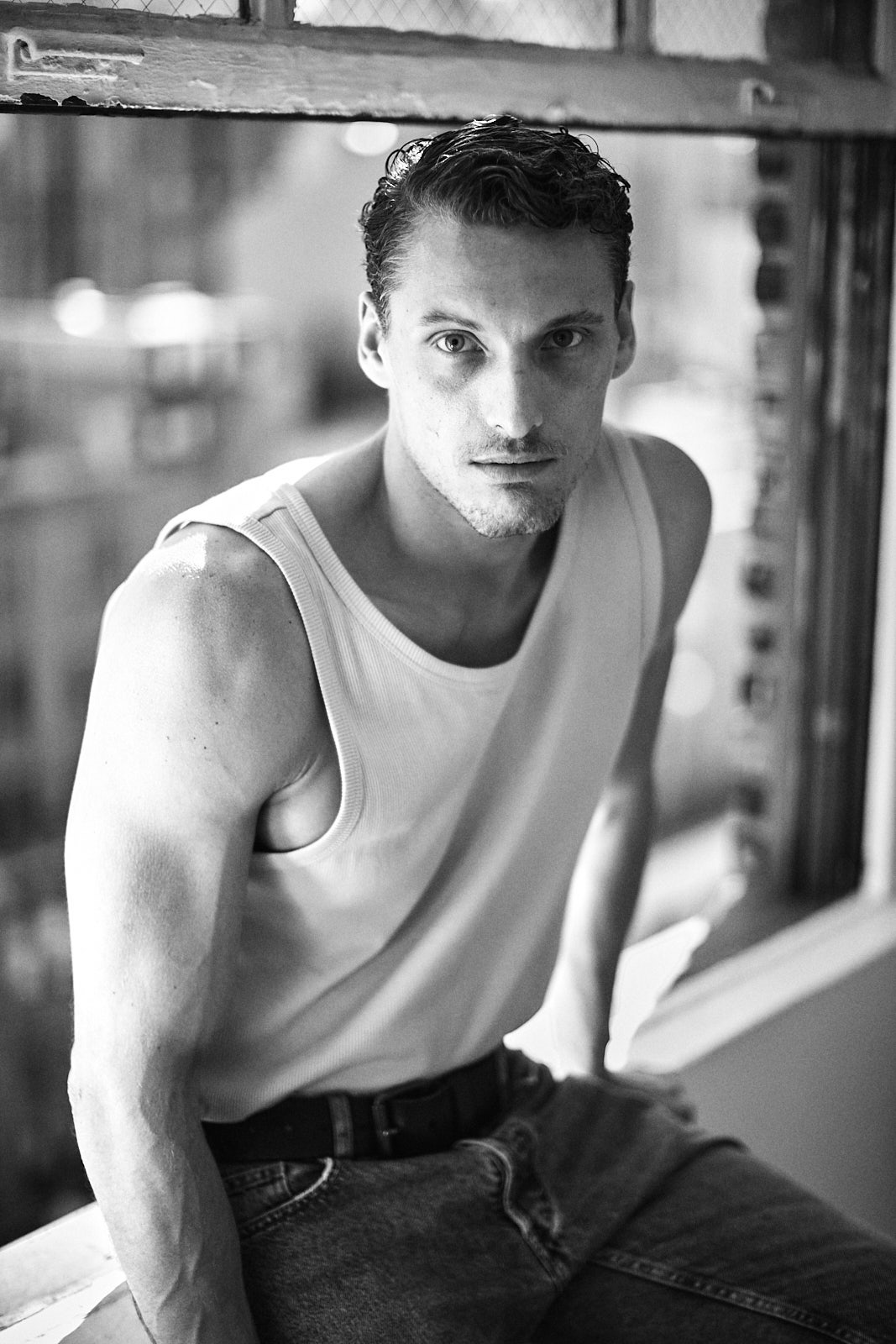 Black and white men’s modeling portrait near window by New York portrait photographer Vikram Pathak