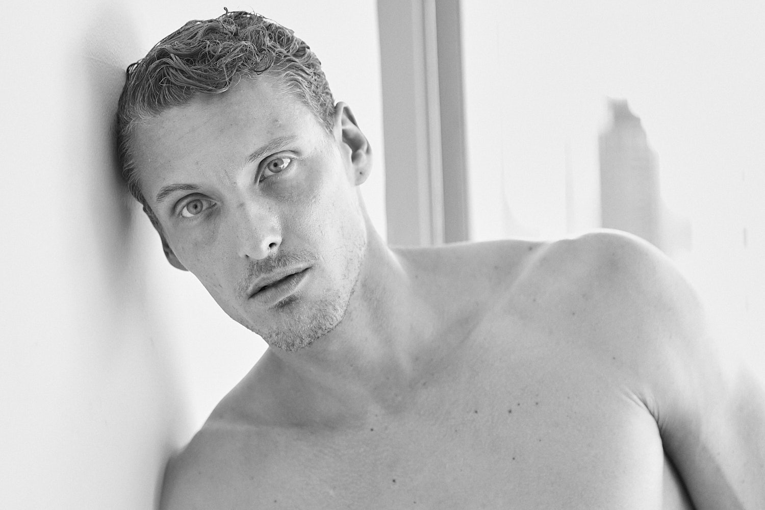 Black and white portrait of a shirtless male model by New York photographer Vikram Pathak