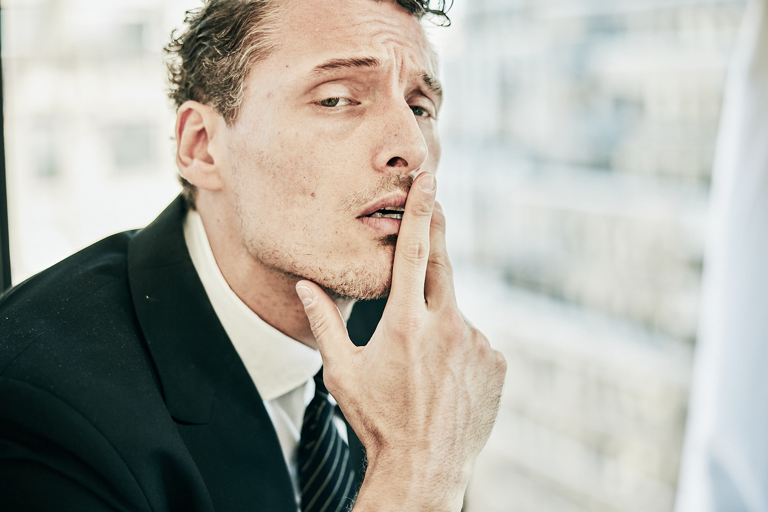 Editorial portrait of a male model in suit and tie by New York fashion photographer Vikram Pathak
