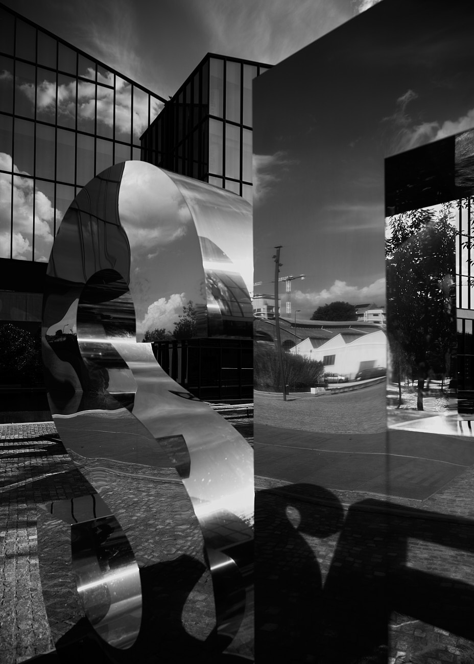 Architectural reflection artwork with metallic surfaces captured in natural light by fashion photographer Vikram Pathak.