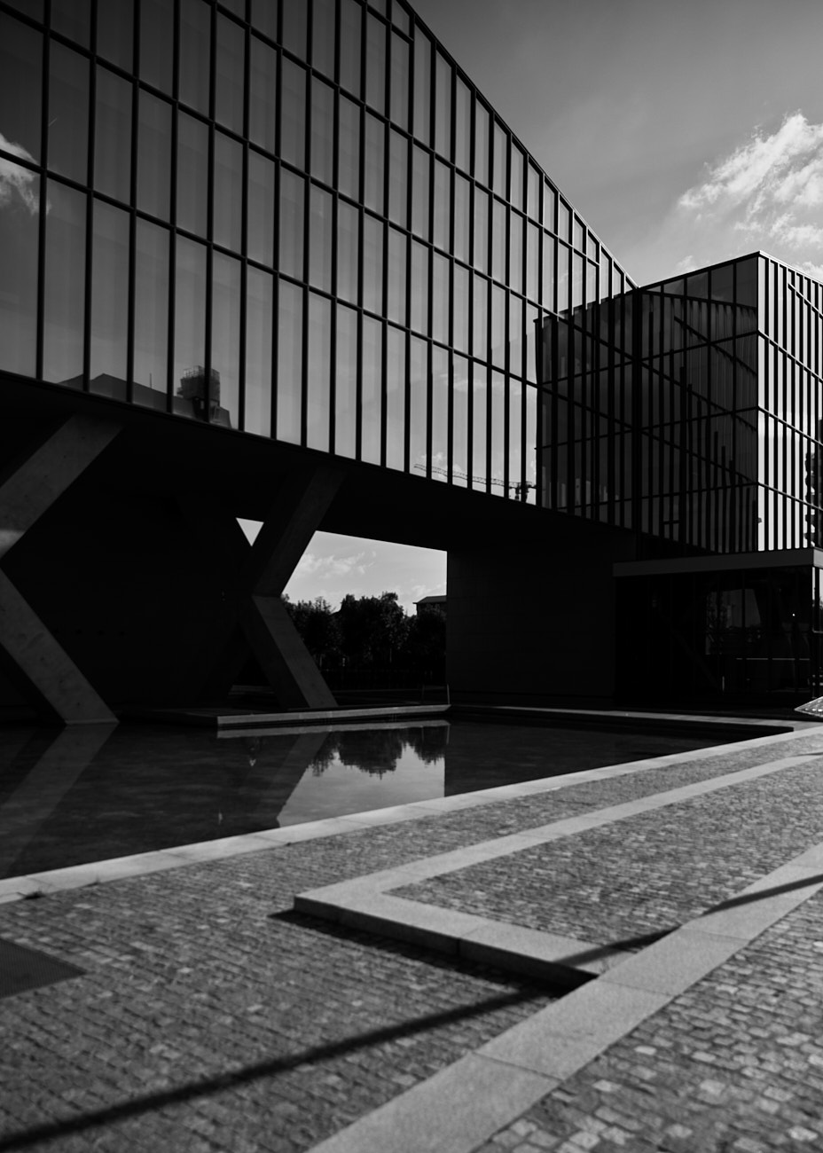 Minimal architectural structure with glass and concrete elements, photographed by Vikram Pathak.