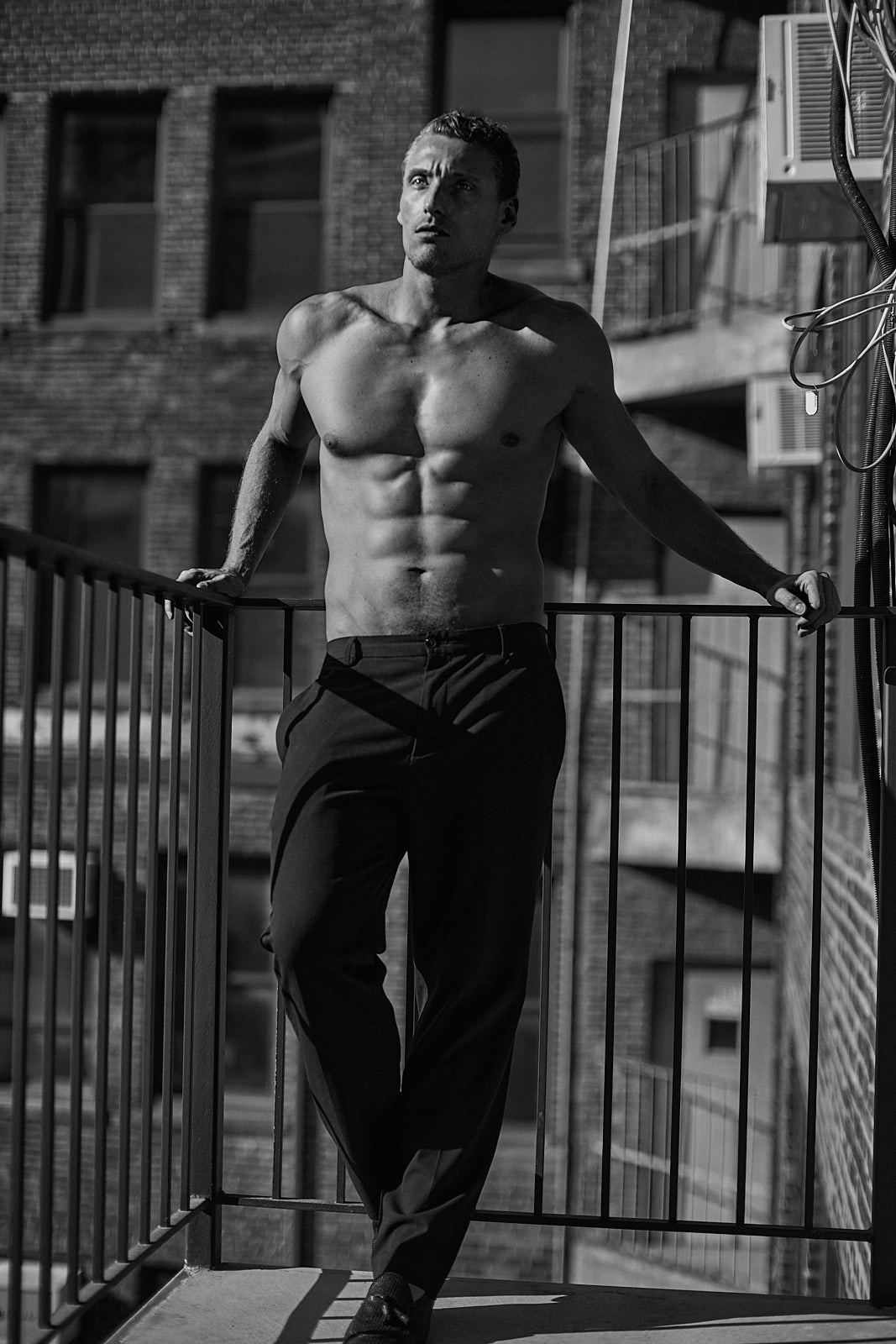 Shirtless male model on rooftop in NYC – men’s modeling portfolio by Vikram Pathak