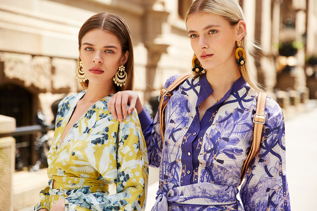 Two models in printed dresses posing for commercial fashion photography in New York