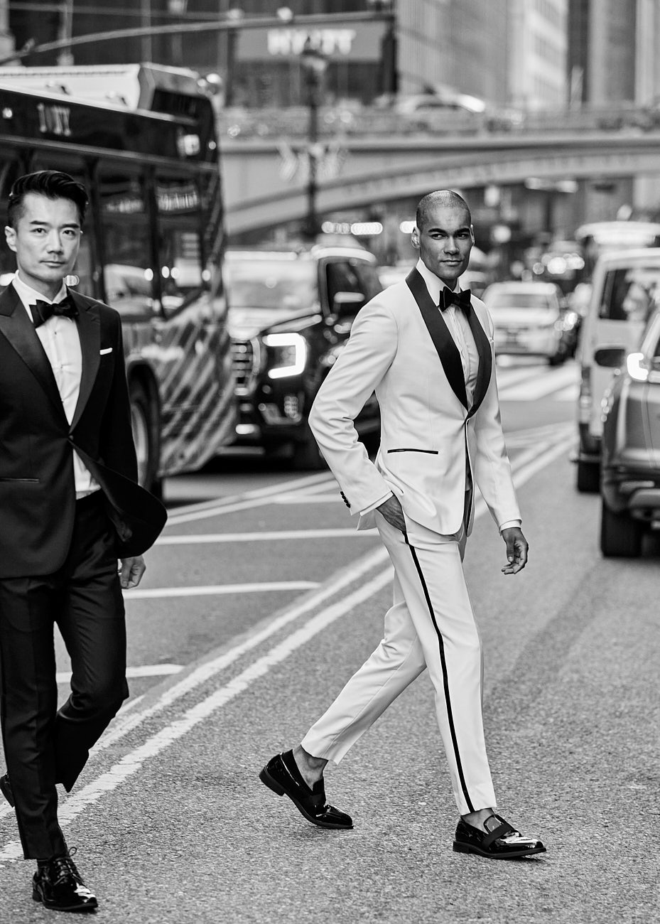 Male models crossing NYC street in black and white tuxedos, photographed in black and white by Vikram Pathak