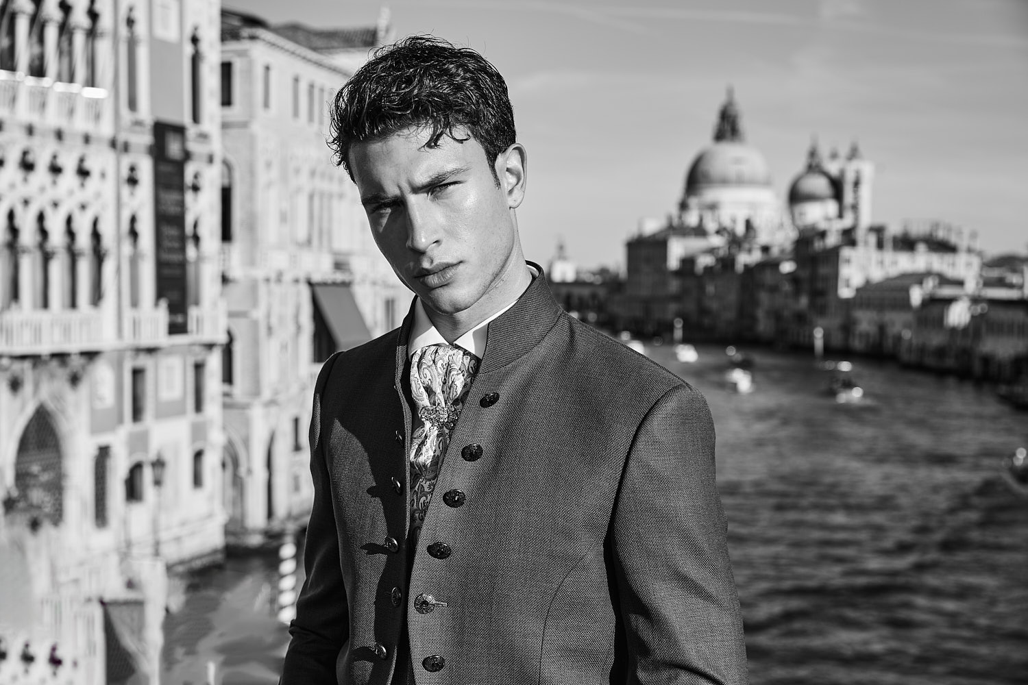 Fashion portrait of male model wearing plum suit near Grand Canal – photographed by Vikram Pathak