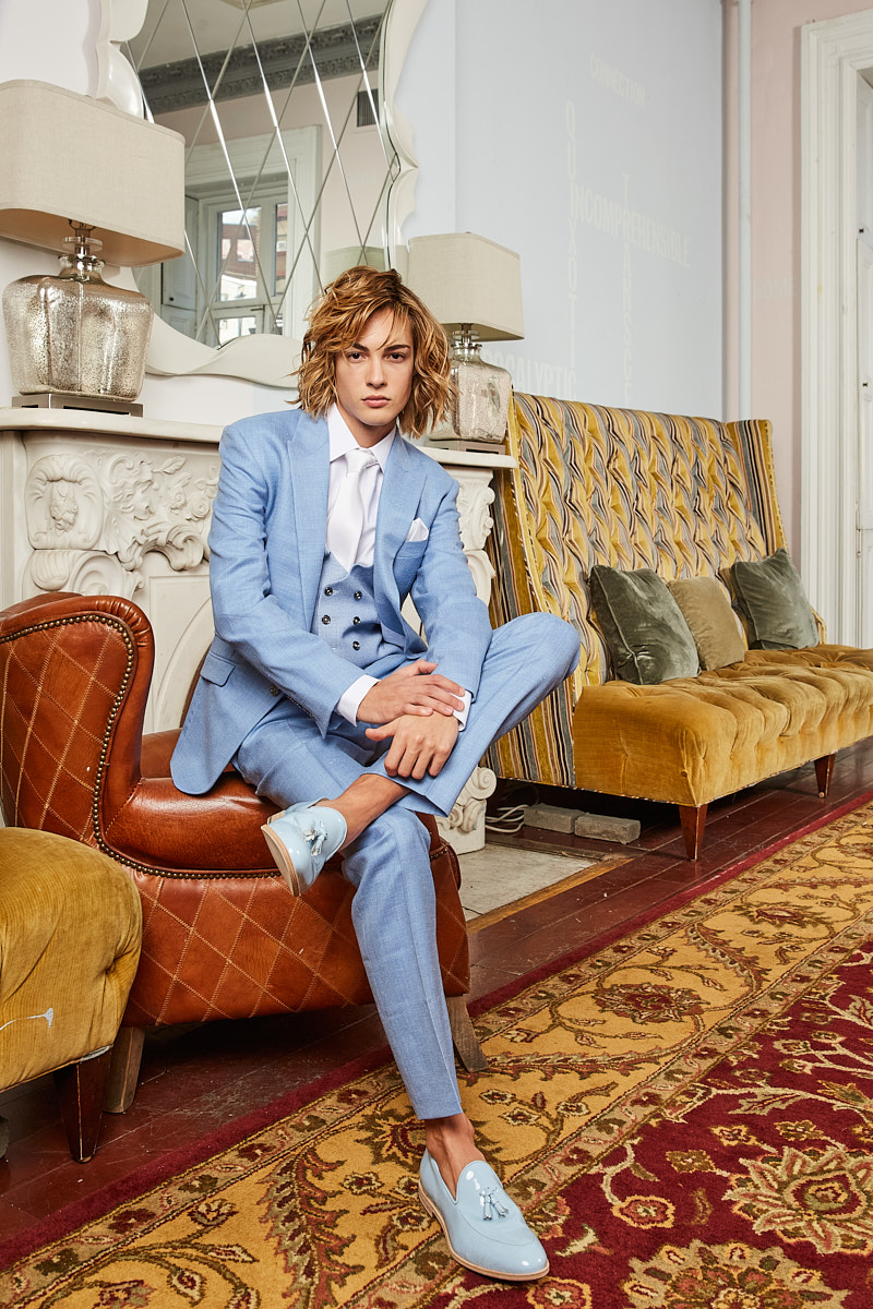 Male model seated in powder-blue suit, New York menswear editorial by Vikram Pathak.