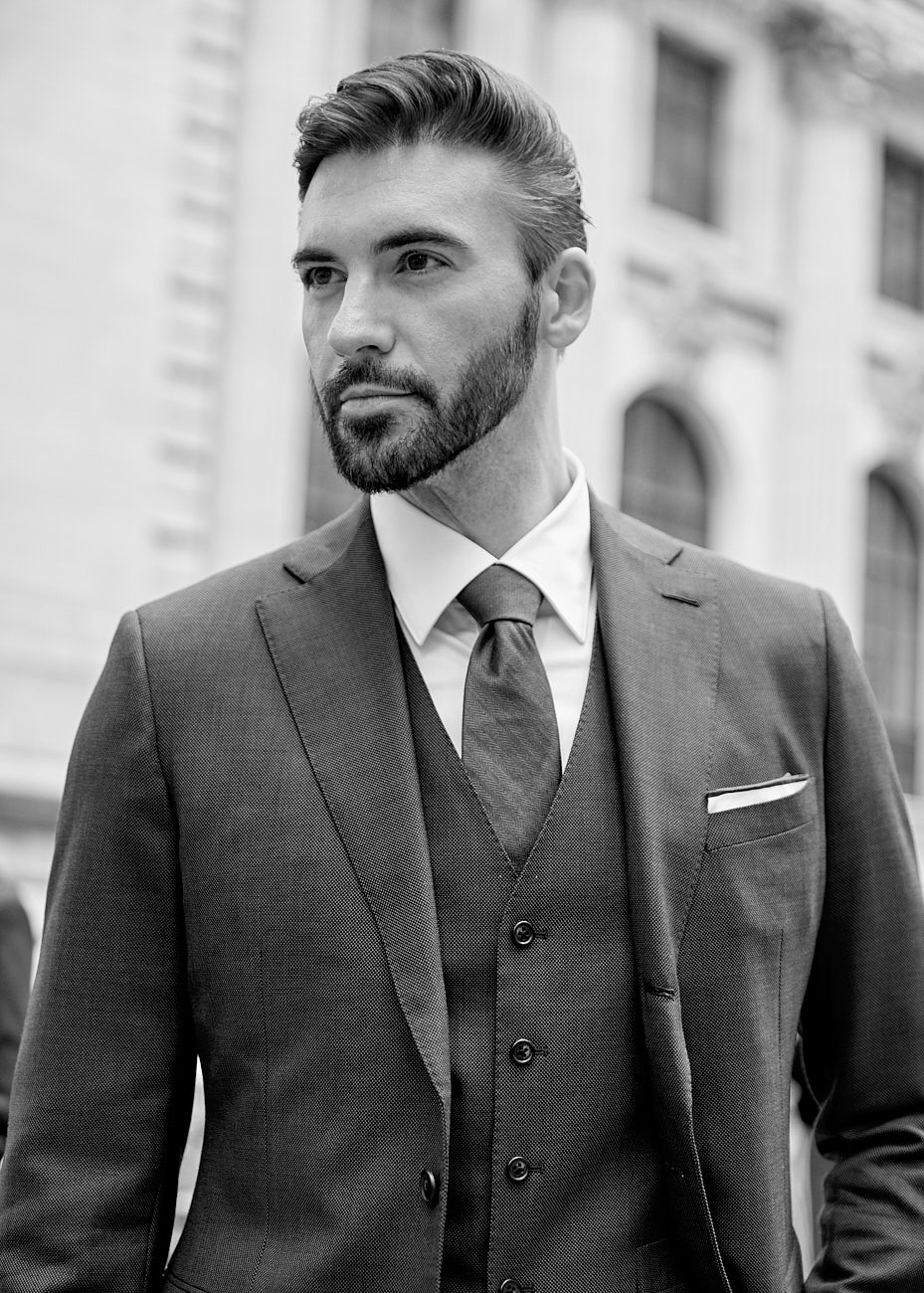 Close-up of male model in three-piece suit in NYC by Vikram Pathak, black and white fashion portrait