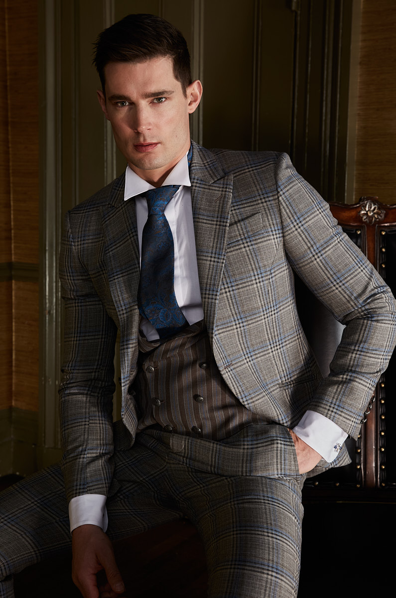 Male model in grey plaid suit photographed in a New York interior by menswear photographer Vikram Pathak.