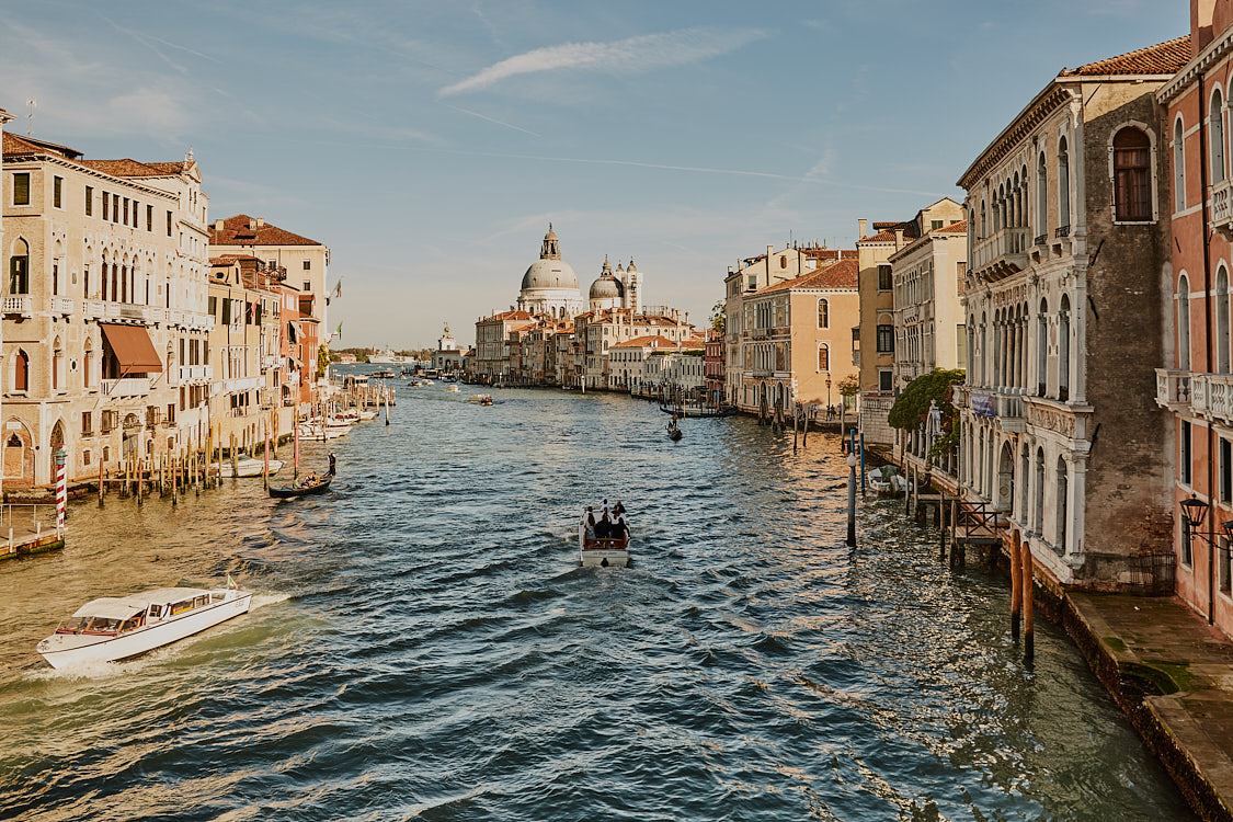 Male model in luxury menswear suit photographed along the Grand Canal, Venice by NYC fashion photographer Vikram Pathak