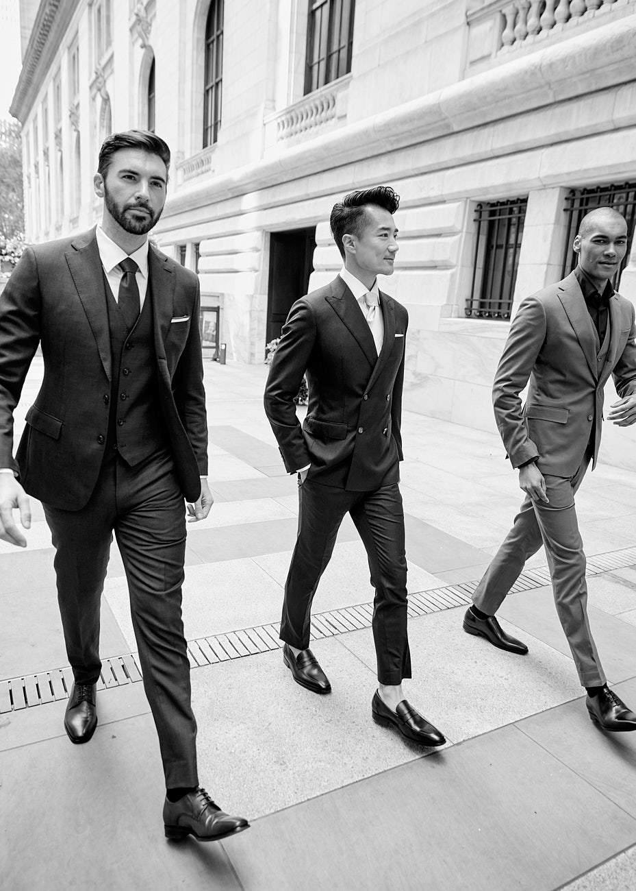 Three male models in formal menswear walking through New York in a fashion editorial by Vikram Pathak