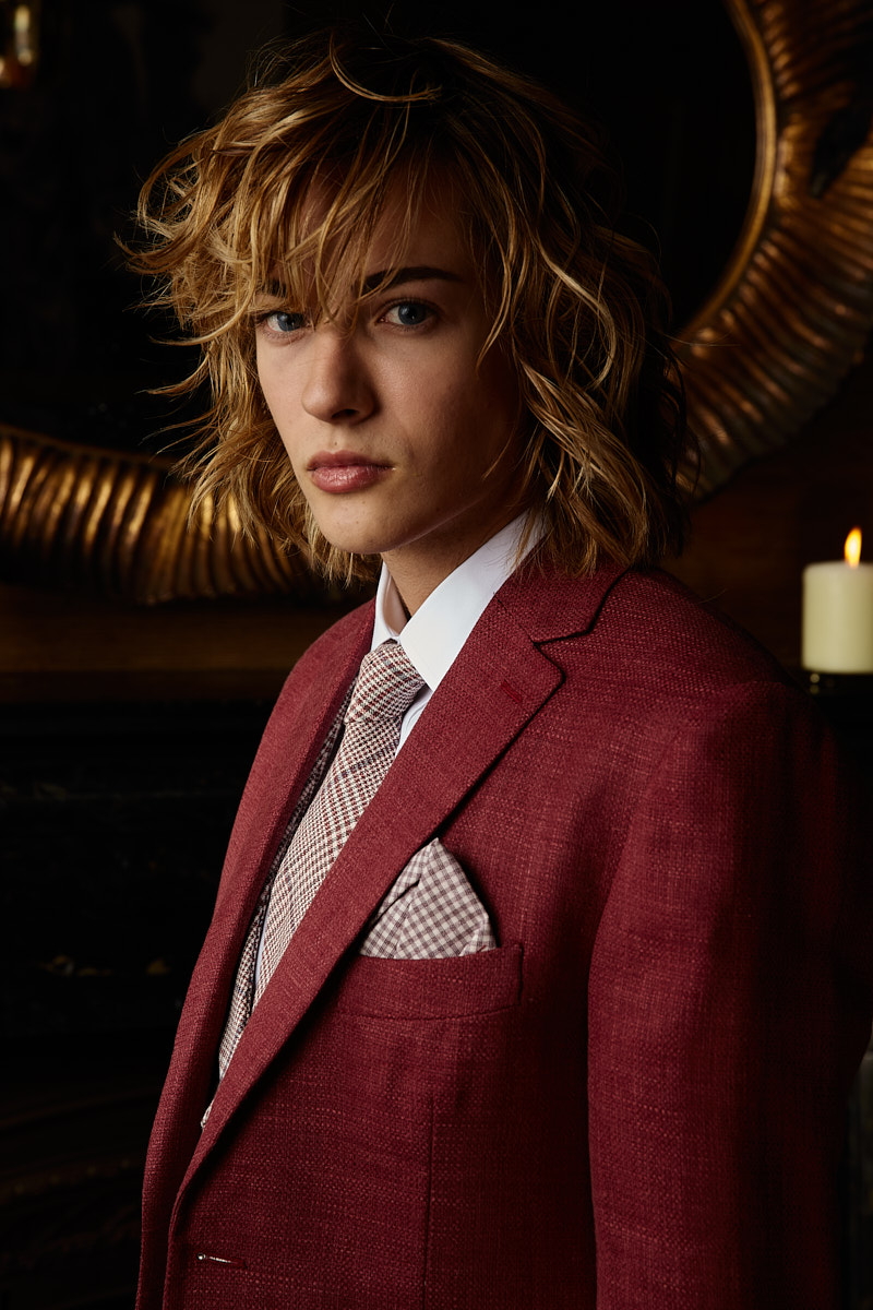 Portrait of male model in red textured suit, New York fashion photography by Vikram Pathak.